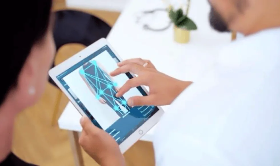 Fachkraft bespricht die Auswertung der Körperanalyse mit einer Teilnehmerin am Tablet